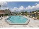Community pool surrounded by lounge chairs and lush landscaping at 4575 Whitton Way # 1132, New Port Richey, FL 34653