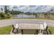 Bench overlooking a community lake on a sunny, partly cloudy day at 4575 Whitton Way # 1132, New Port Richey, FL 34653