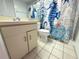 The bathroom has a vanity and a themed shower curtain at 4823 Ebbtide Ln # 105, Port Richey, FL 34668