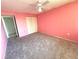 Spacious bedroom with neutral carpet, ceiling fan, and closet at 4823 Ebbtide Ln # 105, Port Richey, FL 34668