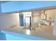 View of kitchen with light countertops, white appliances, and breakfast bar at 4823 Ebbtide Ln # 105, Port Richey, FL 34668