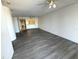 A condo's living room with wood floors and a view of the kitchen at 4823 Ebbtide Ln # 105, Port Richey, FL 34668