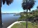 Beautiful water view with swaying palm trees, a boat dock, and lush greenery enhancing the property's appeal at 4823 Ebbtide Ln # 105, Port Richey, FL 34668