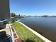 Expansive water views from the property with grassy lawn, a dock, and clear blue skies above at 4823 Ebbtide Ln # 105, Port Richey, FL 34668