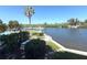 Scenic water view with boats docked in the marina, swimming pool, and manicured landscaping adding to the property's charm at 4823 Ebbtide Ln # 105, Port Richey, FL 34668