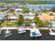Aerial view of waterfront homes featuring private docks, pools, and tropical landscaping at 4917 Marlin Dr, New Port Richey, FL 34652