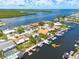 Aerial view of waterfront property with private dock and lush green surroundings at 4917 Marlin Dr, New Port Richey, FL 34652