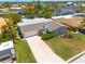 Aerial view of the single Gathering home with lush landscaping, 2-car garage, and private boat dock at 4917 Marlin Dr, New Port Richey, FL 34652