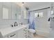Bright bathroom with a white vanity, shower and tub combination, and blue accents at 4917 Marlin Dr, New Port Richey, FL 34652
