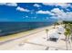 Stunning ocean view with white sand, palm trees, and blue skies, offering a serene coastal experience at 4917 Marlin Dr, New Port Richey, FL 34652