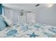 Coastal bedroom featuring ocean-themed bedding, white dresser, and ample closet space at 4917 Marlin Dr, New Port Richey, FL 34652