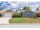 Charming single Gathering home featuring an attached two car garage, chimney, and beautifully landscaped front yard at 4917 Marlin Dr, New Port Richey, FL 34652