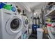 Functional laundry room with washer, dryer, storage and utility features at 4917 Marlin Dr, New Port Richey, FL 34652