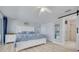 Bright main bedroom with ensuite bath, light wood floors, ceiling fan, and access to the lanai at 4917 Marlin Dr, New Port Richey, FL 34652