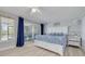 Bright main bedroom features light wood floors, ceiling fan, and access to the lanai at 4917 Marlin Dr, New Port Richey, FL 34652