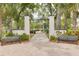 Entrance to Sims Park, showcasing a brick pathway, lush greenery, and inviting benches at 4917 Marlin Dr, New Port Richey, FL 34652