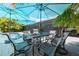 Outdoor dining area with patio furniture and a view of the pool and tropical surroundings at 4917 Marlin Dr, New Port Richey, FL 34652