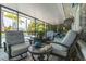 Relaxing screened-in patio with comfortable seating overlooking the pool and tropical landscape at 4917 Marlin Dr, New Port Richey, FL 34652