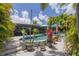 Outdoor pool area surrounded by lush landscaping and a screened-in patio at 4917 Marlin Dr, New Port Richey, FL 34652