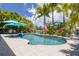 Inviting pool surrounded by tropical landscaping and palm trees at 4917 Marlin Dr, New Port Richey, FL 34652