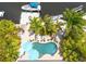 Aerial view of backyard featuring a free form pool, patio with lounge seating, and private dock at 4917 Marlin Dr, New Port Richey, FL 34652