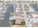 Aerial view of a home with waterfront access and a private dock, surrounded by lush landscaping at 4937 Dory Dr, New Port Richey, FL 34652