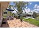 Charming back patio with patterned tile, an umbrella, and waterfront views creating a relaxing outdoor space at 4937 Dory Dr, New Port Richey, FL 34652