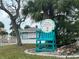 Entrance to a private beach club with a palm tree, beach chair and lush landscaping around at 4937 Dory Dr, New Port Richey, FL 34652