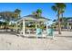 Community beach pavilion featuring outdoor seating near the beach, all surrounded by beautiful palm trees and nature at 4937 Dory Dr, New Port Richey, FL 34652