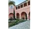 Charming courtyard with lush landscaping, arches, and outdoor seating at 4937 Dory Dr, New Port Richey, FL 34652