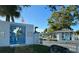 Unique entrance gate featuring a palm tree design and a dolphin statue at 4937 Dory Dr, New Port Richey, FL 34652