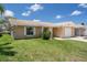 Charming single-story home with a well-manicured lawn and attached garage, located on a waterfront property at 4937 Dory Dr, New Port Richey, FL 34652