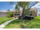 Charming front yard with a mature tree, lush lawn, and a well-maintained exterior at 4937 Dory Dr, New Port Richey, FL 34652