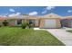 Charming single-story home with a well-maintained lawn and attached garage at 4937 Dory Dr, New Port Richey, FL 34652