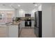 Modern kitchen featuring white cabinets, stainless steel appliances, and granite countertops at 4937 Dory Dr, New Port Richey, FL 34652