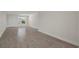Spacious living room with neutral tones, tiled flooring, and ample natural light at 4937 Dory Dr, New Port Richey, FL 34652