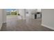 Bright living room featuring tiled floors, a large window, and seamless flow to the kitchen at 4937 Dory Dr, New Port Richey, FL 34652