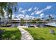 Picturesque waterfront view featuring lush greenery, docks, and houses across the calm water at 4937 Dory Dr, New Port Richey, FL 34652