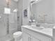 Modern bathroom featuring white vanity with sink, glass shower and decorative tile accents at 5001 Night Star Trl, Odessa, FL 33556