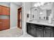 This bathroom features a closet, black vanity, and a large mirror at 5001 Night Star Trl, Odessa, FL 33556
