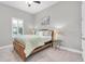 Bright bedroom with light green bedding, plantation shutters, and ample natural light at 5001 Night Star Trl, Odessa, FL 33556