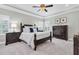Spacious primary bedroom suite features tray ceiling, large bed, and dresser at 5001 Night Star Trl, Odessa, FL 33556