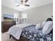 Well-lit bedroom featuring a ceiling fan, wooden dresser, and a TV for entertainment at 5001 Night Star Trl, Odessa, FL 33556