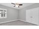 Simple bedroom featuring a ceiling fan, plush carpeting and plantation shutters for light control at 5001 Night Star Trl, Odessa, FL 33556