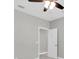 Bare bedroom with neutral tones, ceiling fan, open door, and closet providing space and comfort at 5001 Night Star Trl, Odessa, FL 33556