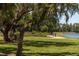 Walking trail running along community lake lined with mature trees and scenic views creating a tranquil atmosphere at 5001 Night Star Trl, Odessa, FL 33556