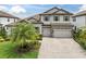 Elegant two-story home featuring a neutral color palette, tile roof, three-car garage and professionally landscaped yard at 5001 Night Star Trl, Odessa, FL 33556
