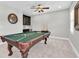 This game room boasts a pool table, wet bar, and a ceiling fan at 5001 Night Star Trl, Odessa, FL 33556