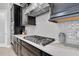 Well appointed kitchen with stainless appliances, modern hood, and white backsplash at 5001 Night Star Trl, Odessa, FL 33556