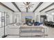 Bright living room features high ceilings with wooden beams, a decorative stone fireplace and comfortable seating at 5001 Night Star Trl, Odessa, FL 33556